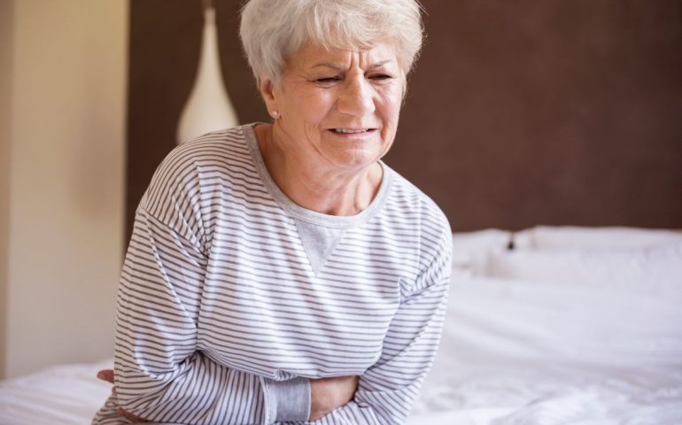 Old woman with stomache pains