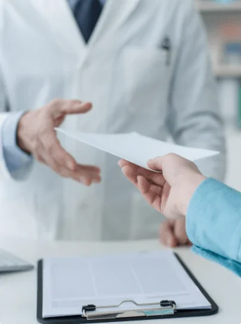 Customer passing a document to a pharmacist
